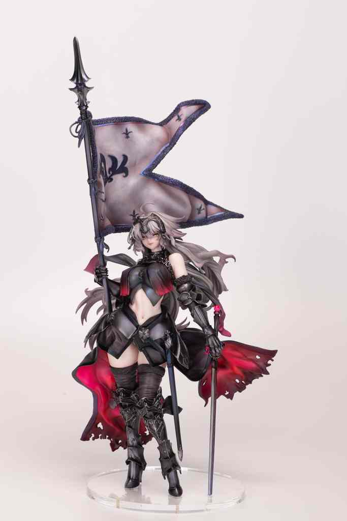 A detailed collectible figure of a female character dressed in a dark outfit with a red cape, holding a spear and a flag with intricate designs.