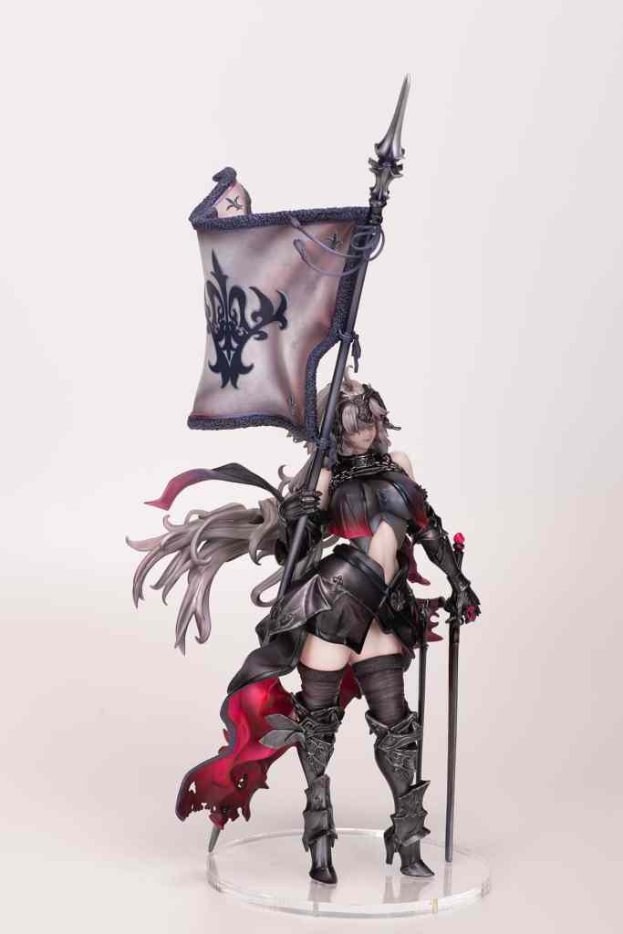 A detailed figurine of a female character holding a flag and a spear, wearing dark armor with intricate designs and a flowing cape.