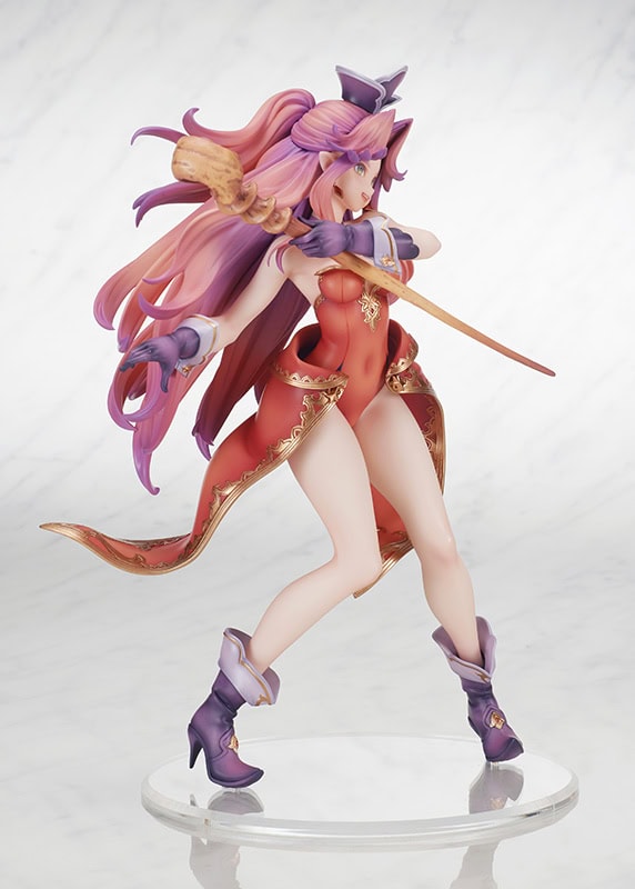 A detailed figure of a fantasy character with long pink hair, dressed in a red outfit and purple accents, holding a staff. The figure is posed dynamically with a flowing cape and stands on a transparent base.