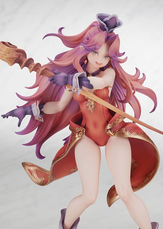 A detailed figure of a character with long pink hair, wearing a red outfit and holding a staff, posed dynamically against a light background.