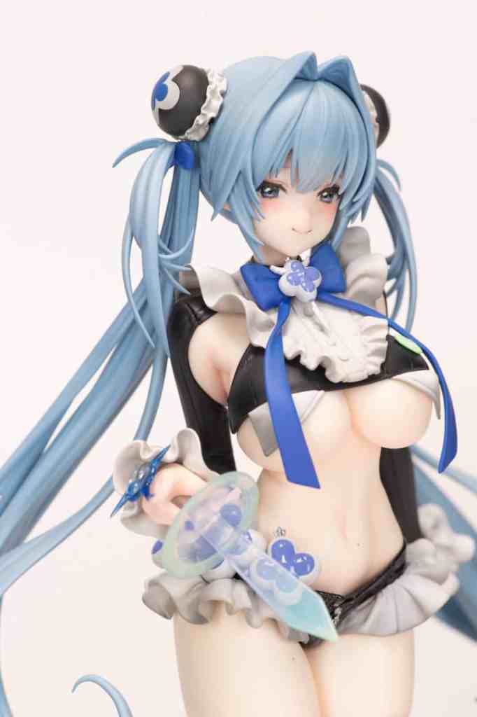 A detailed figure of a character with blue hair styled in twin tails, wearing a black and white outfit with frills and blue accessories, holding a translucent weapon.