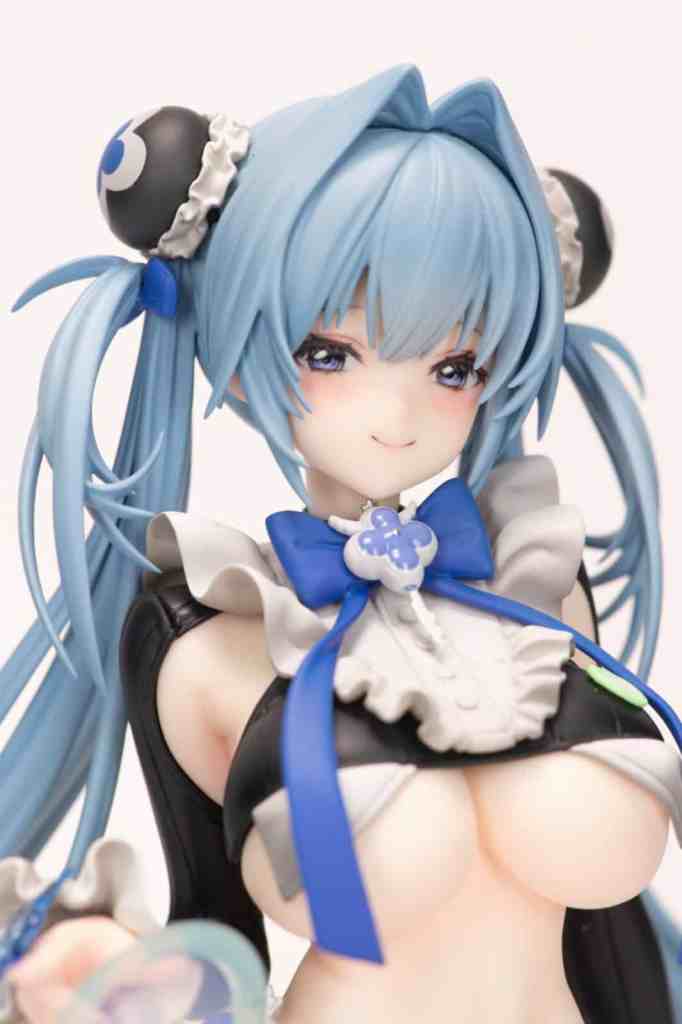 Close-up of a stylized figure with blue hair and a maid outfit, featuring large eyes and a playful expression.